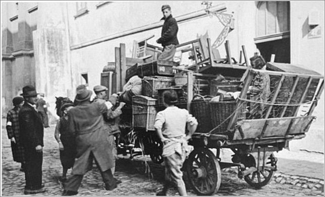 Jews move their belongings in horse-drawn wagons